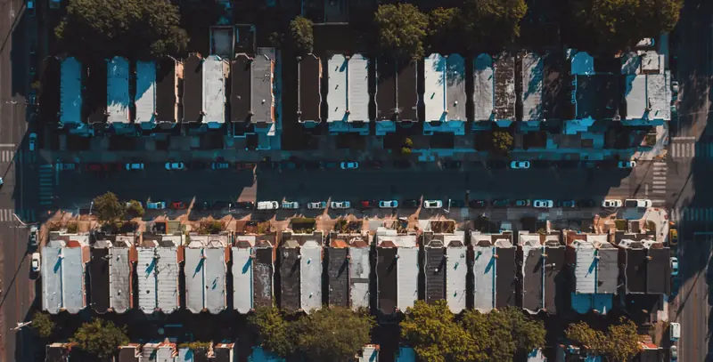 Aerial view of rowhouse roofs and a street
